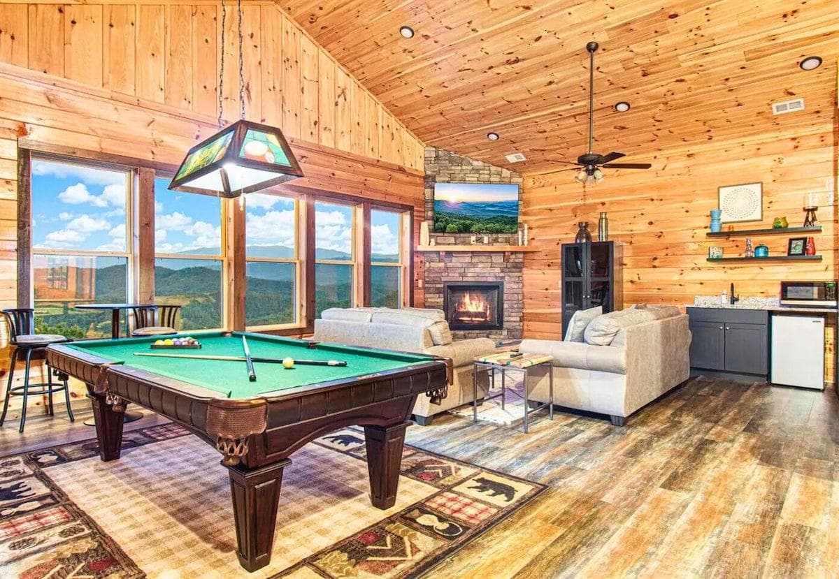 Upstairs Lounge Area with Large Open Windows, Pool Table, Fireplace and Seating and a Wet Bar