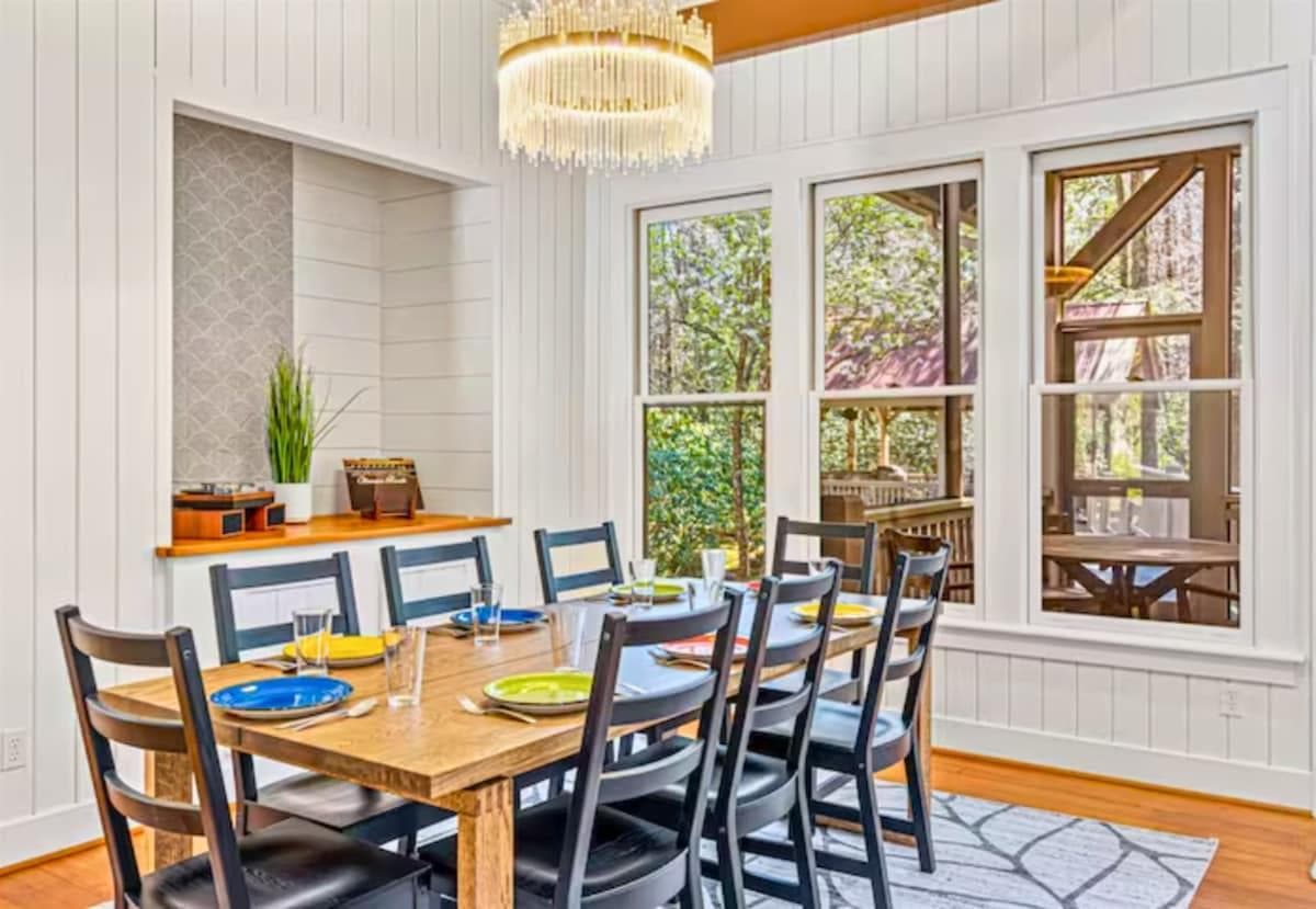 Seating for 8 at the Dining Table in the Dining Room with Large Windows